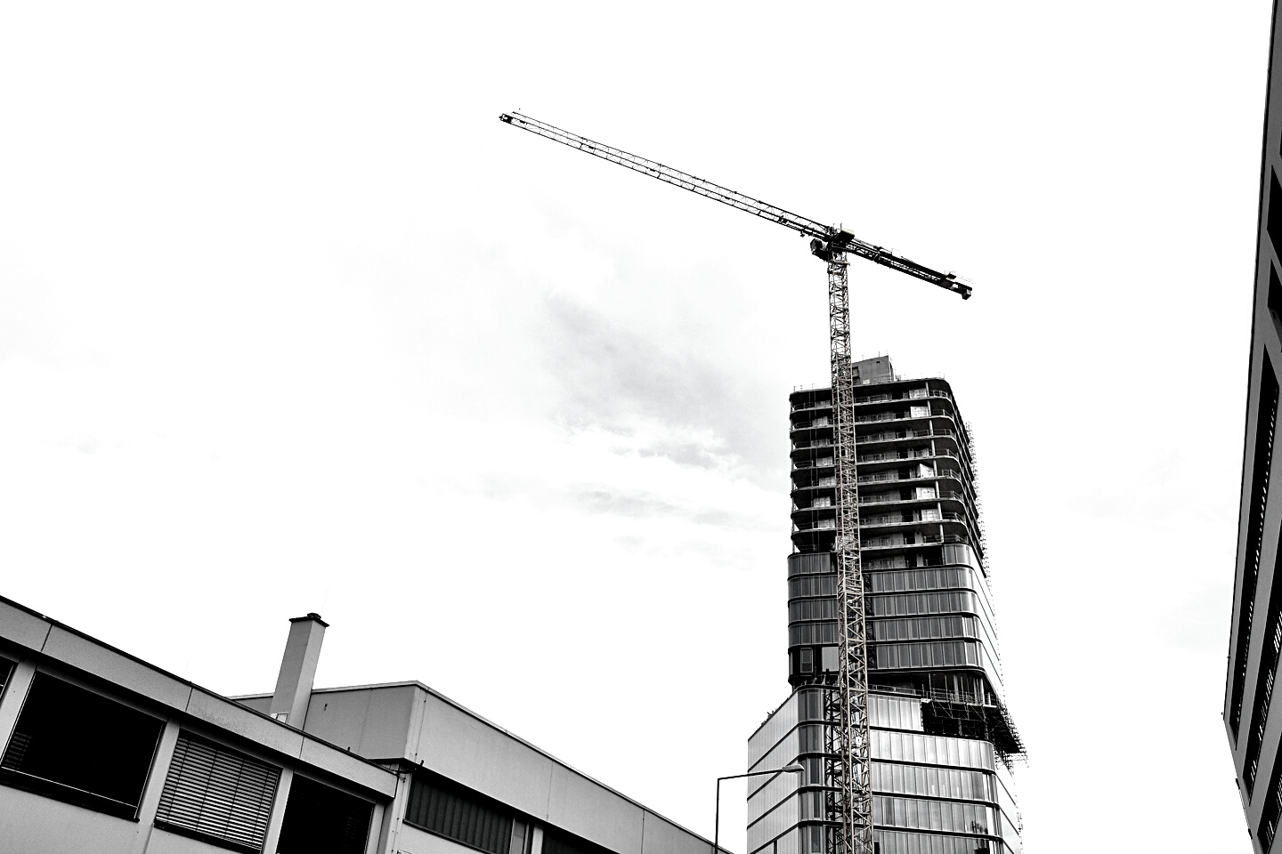 Yellow Tower Crane Beside the Concrete Building